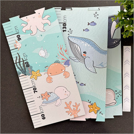 Growth chart ruler featuring vibrant sea life patchwork design, includes puzzle pieces and markers for tracking child's height.