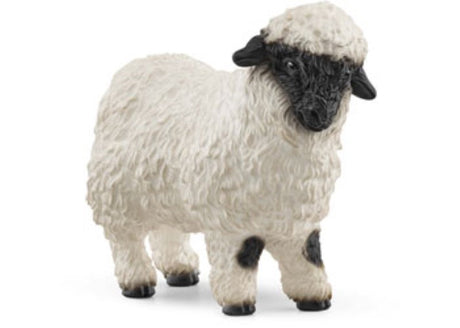 Charming Schleich Valais Blacknose Sheep figurine showcasing its distinctive black face and woolly coat, perfect for collectors.