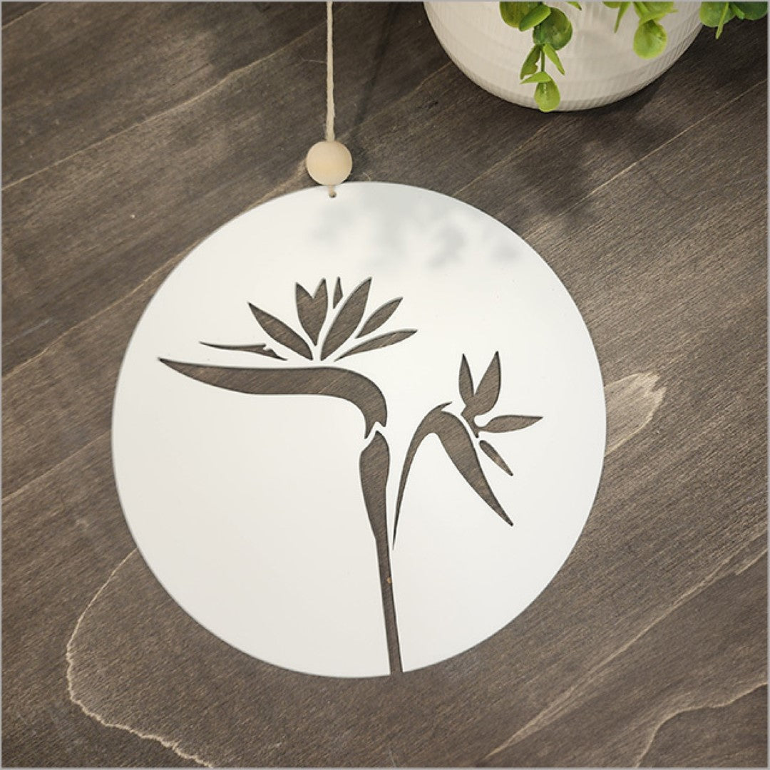 Hanging acrylic circle wall art featuring a white Bird of Paradise design, perfect for stylish home decor.