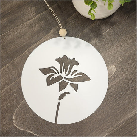 Hanging acrylic circle featuring a white daffodil design, perfect for modern wall decor and Kiwiana-themed spaces.