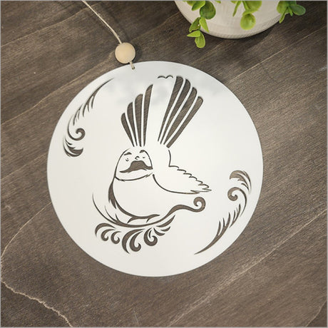 Kiwiana wall art featuring a white acrylic circle of a fantail, perfect for enhancing home decor with a touch of New Zealand.