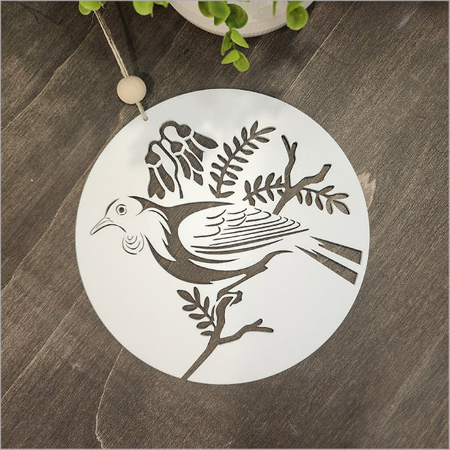 Hanging acrylic circle wall art featuring a tui bird, perfect for Kiwiana-inspired home decor.