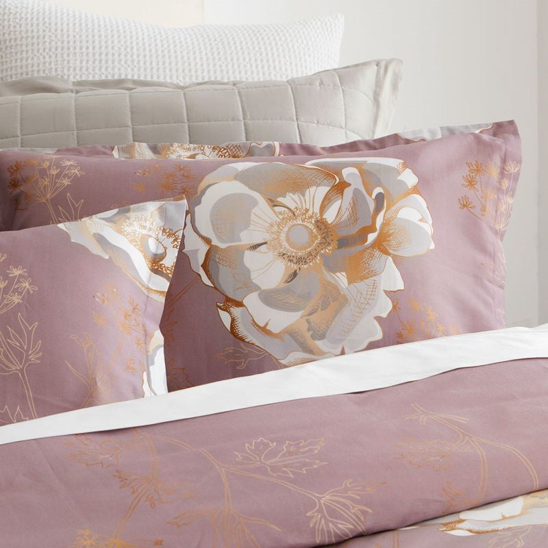 Mauve Eden duvet cover set featuring floral design with gold accents, includes a king single cover and two pillowcases.