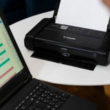 Canon PIXMA TR150 portable inkjet printer in black, featuring vibrant color printing, Wi-Fi connectivity, and a 1.44" OLED display.