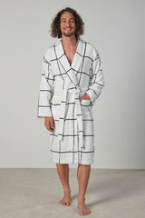 Luxurious white velour robe with large check design, shawl collar, pockets, and waist tie, ethically made in Turkey.