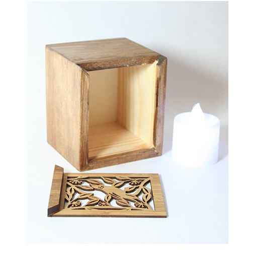 LED Tealight Box in bamboo, featuring intricate laser-cut designs and a color-changing LED candle, doubles as a trinket holder.