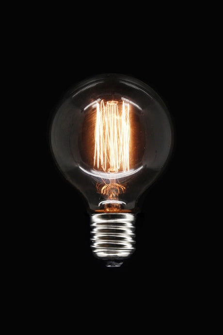 Dimmable G80 25W E27 tungsten bulb with elegant squirrel cage filament, perfect for decorative lamps and warm ambiance.