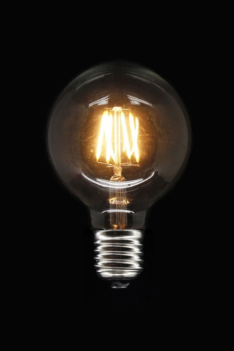 Dimmable G95 E27 LED bulb with ceramic filament, warm white glow, ideal for elegant lighting in various fixtures.