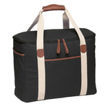 Sleek black Hamptons Cooler made of waxed cotton canvas, featuring insulated compartment, faux leather trim, and durable carry handles.
