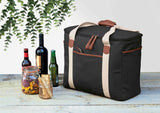 Hamptons Cooler in sleek black, crafted from luxury waxed canvas with faux leather, featuring insulated compartment and stylish design.