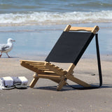 Wave Beach Chair: Foldable bamboo chair with black canvas backrest, lightweight, portable, perfect for beach outings.