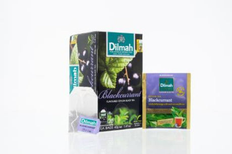 Foil-wrapped tea bags of Dilmah's Blackcurrant Flavoured Ceylon Black Tea, offering a tart-sweet blend in each bag.