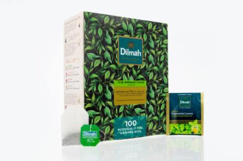 Close-up of Dilmah Peppermint Tea Bags in foil envelopes, showcasing 100 individually wrapped bags for freshness and flavor.