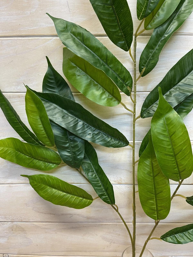 Lifelike long green mango leaf spray, ideal for vibrant tropical decor, easy to maintain and perfect for various arrangements.
