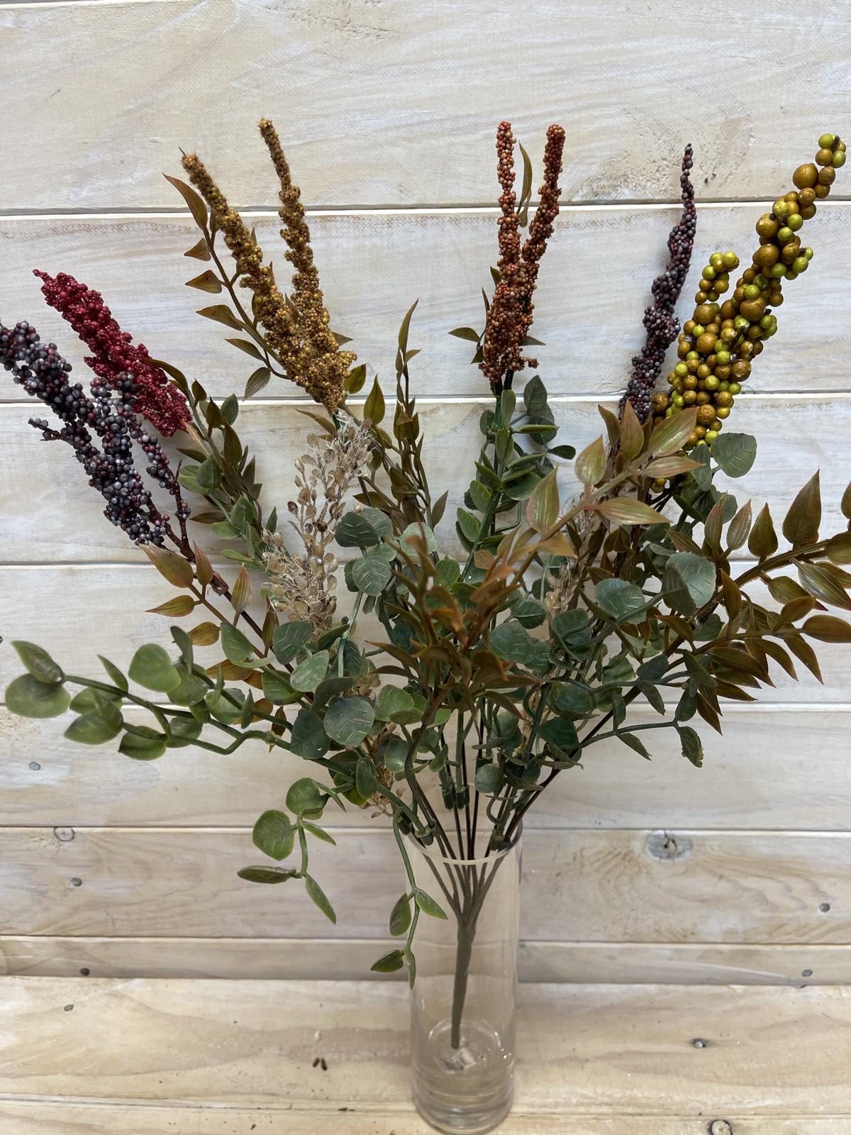 Vibrant faux autumn floral arrangement featuring golden yellow, deep orange, and rustic brown hues for cozy year-round decor.