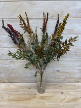 A vintage-inspired artificial flower bush in rich autumn hues of yellow, orange, and brown for year-round decor.