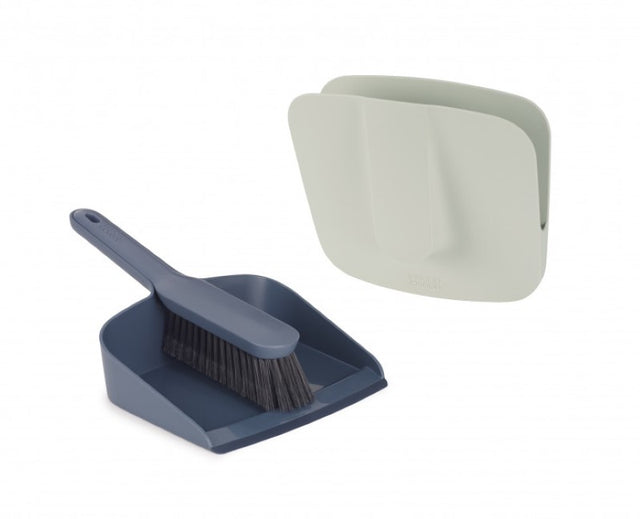 Joseph Joseph CleanStore Dustpan & Brush in wall-mounted holder, featuring soft bristles and rubber edge for efficient cleaning.