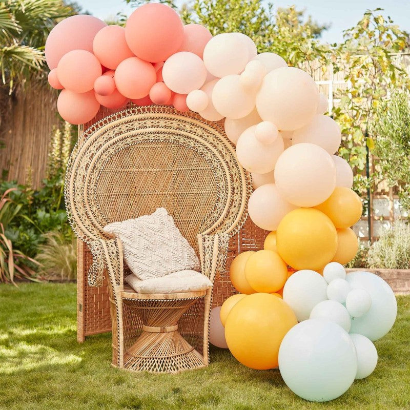 Muted pastel balloon arch kit with 75 balloons in coral, pink, peach, yellow, and mint green for dreamy celebrations.