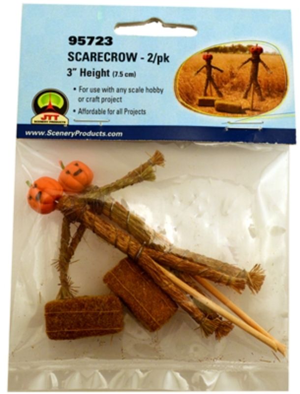 A vibrant scarecrow stands among realistic hay bales, enhancing model landscapes with rural charm and authenticity.