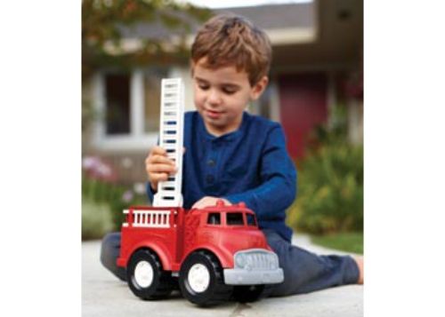 Eco-friendly Green Toys Fire Truck made from recycled plastic, featuring a rotating ladder and removable side ladders for imaginative play.