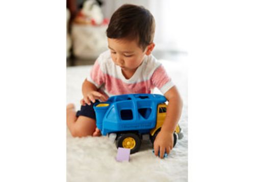 Eco-friendly Green Toys Shape Sorter Truck with 4 colorful shapes, hinged garbage bin, and a functional back door for creative play.