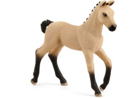 A beautiful red dun Hannoverian foal by Schleich, showcasing a light coat, dark mane and legs, and a refined posture.