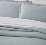 Stonewashed duck egg super king bedspread set by BAKSANA, featuring self-stitched texture and mitred corners.