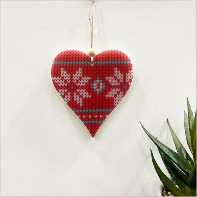 Red knit heart-shaped hanging ornament made from durable satin acrylic, perfect for holiday or year-round decor.