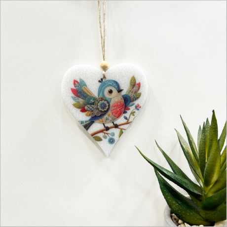 Heart-shaped bird ornament with open wings, intricately printed on satin acrylic, perfect for home decor or gifts.