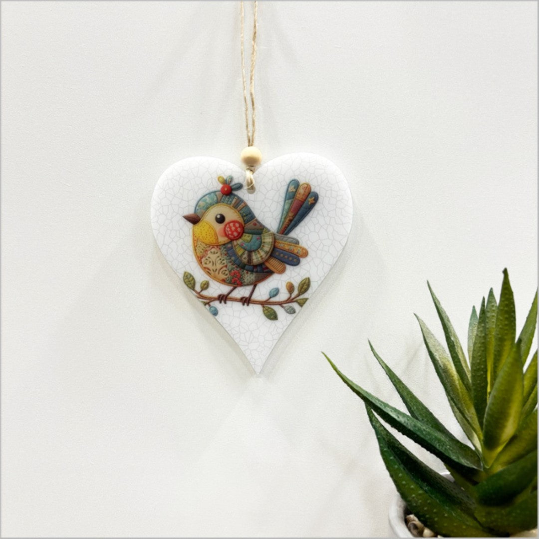 Satin acrylic hanging ornament featuring a heart-shaped bird design with closed wings, measuring 95mm x 105mm.