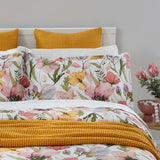 Duvet cover set featuring spring flowers in pink, yellow, and green on white, made from 100% cotton sateen, OEKO-TEX certified.