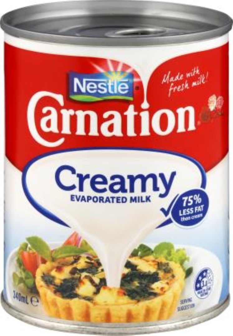 A 340ML can of Nestle's Carnation Creamy Evaporated Milk, offering rich flavor with 75% less fat, perfect for cooking and baking.