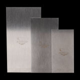 Set of three Footprint Cabinet Scrapers made from high carbon spring steel for precise wood shaping and finishing.