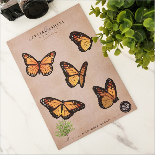 Colorful laser-cut monarch butterflies in a vibrant wall art set, perfect for versatile home decor arrangements.