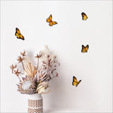 Vibrant laser-cut monarch butterflies on textured board, perfect for adding elegance to any living space.