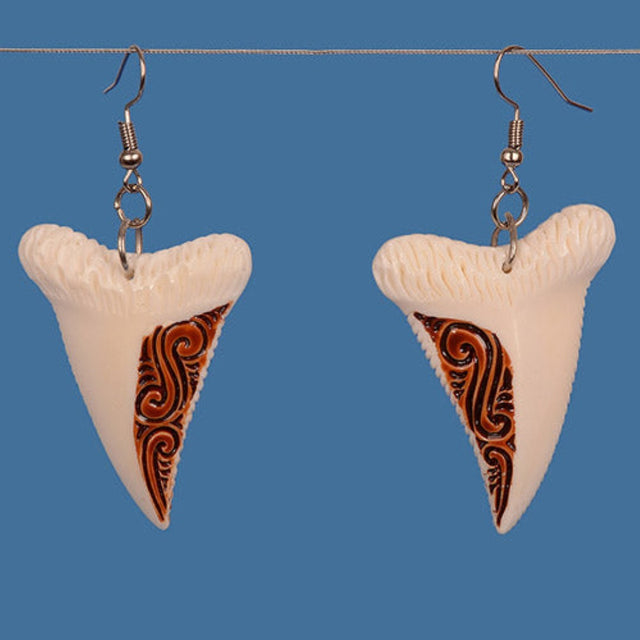 Faux shark tooth bone drop earrings with intricate tribal patterns, crafted with sterling silver hooks for a stylish, adventurous look.