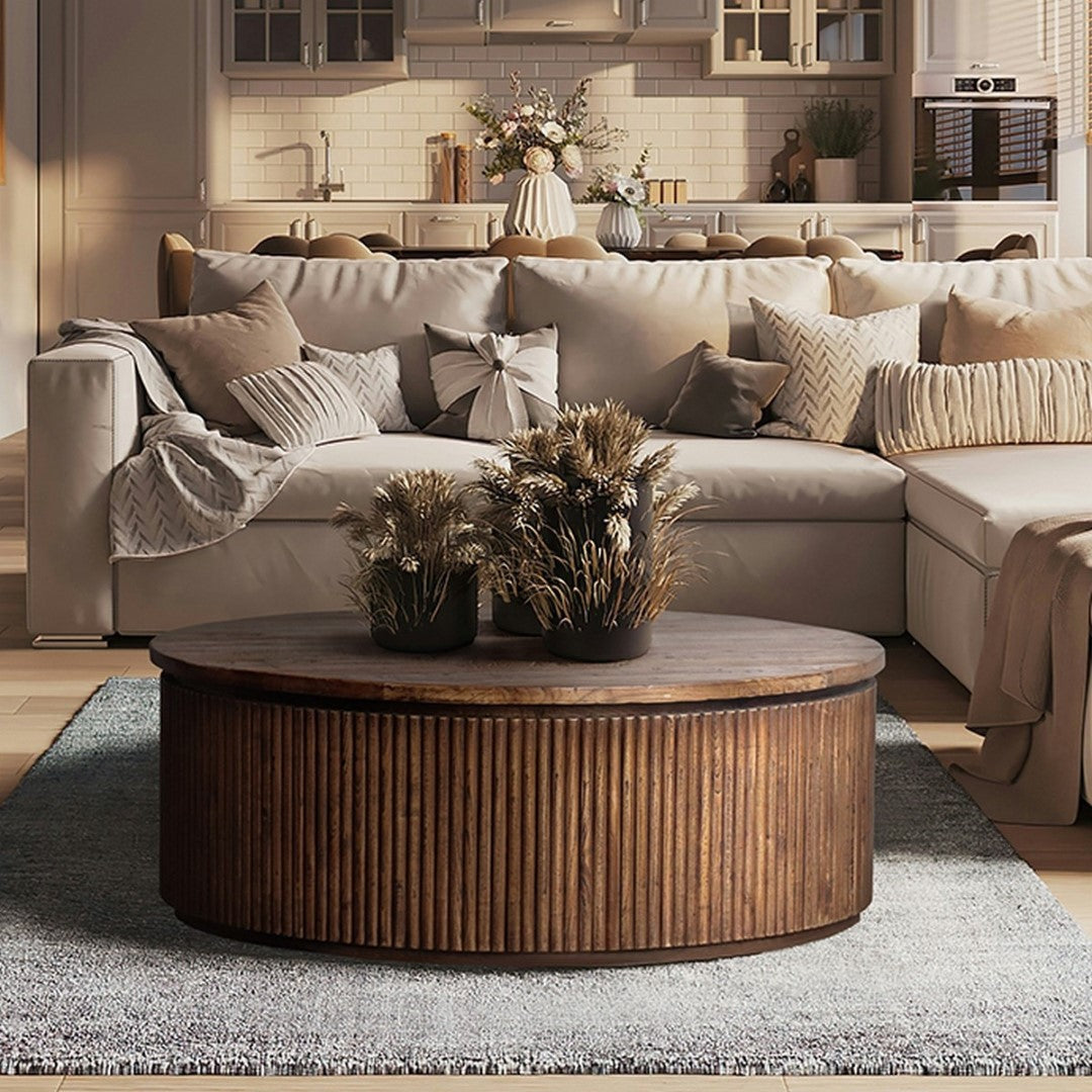 Round Old Elm coffee table (1.1m) with a natural finish, perfect for books and decor, blending elegance and functionality.