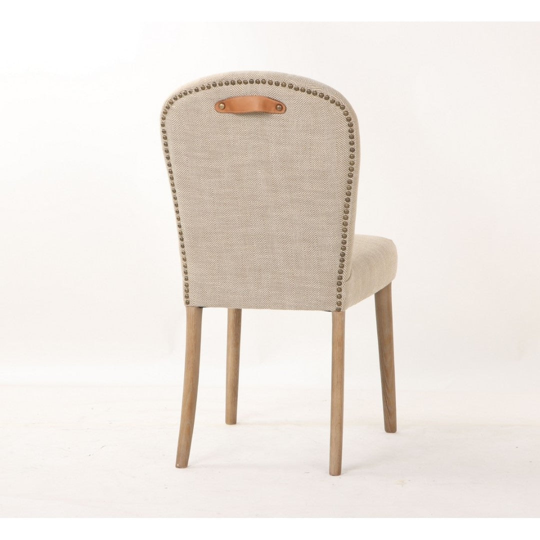 Amberley fabric dining chair with leather handle and studs, showcasing cozy upholstery and a stylish industrial design.