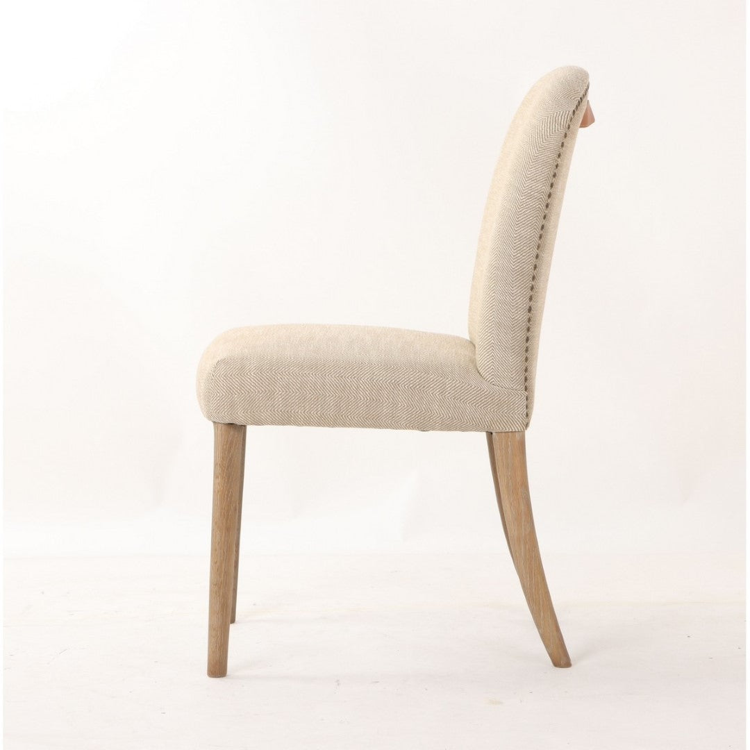 Amberley fabric dining chair with leather handle, studded edges, and a natural ash wood frame, ideal for stylish dining spaces.