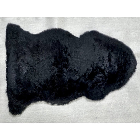 Luxurious black Kaikoura Long Wool NZ Sheepskin (60x90cm) for warmth and style in any home setting.