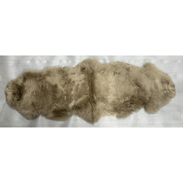 Taupe long wool double sheepskin rug, measuring 60cm x 1.8m, offers luxurious softness and warmth for elegant home decor.