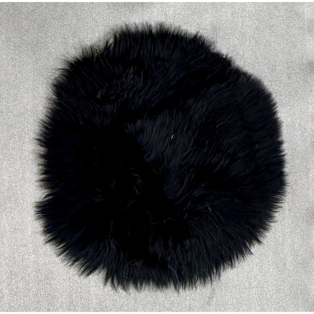 Luxurious black sheepskin seat pad (34x34cm) providing warmth and comfort for chairs and benches, enhancing any decor.