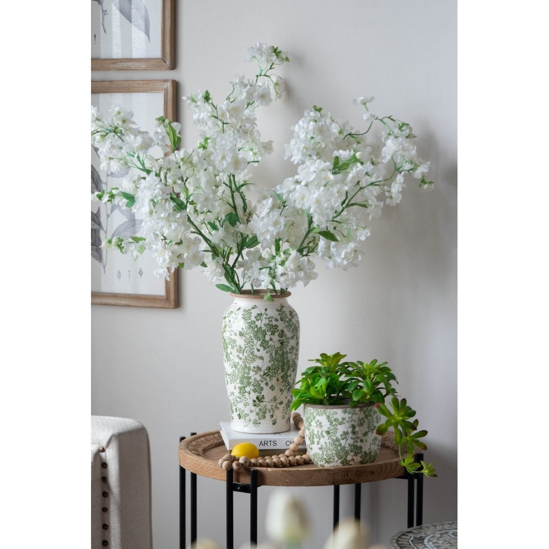 Elegant ceramic flower vase in green and white, perfect for displaying fresh or artificial blooms in any home decor.