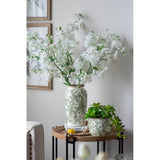 Elegant ceramic flower vase in green and white, perfect for displaying fresh or artificial blooms in any home decor.