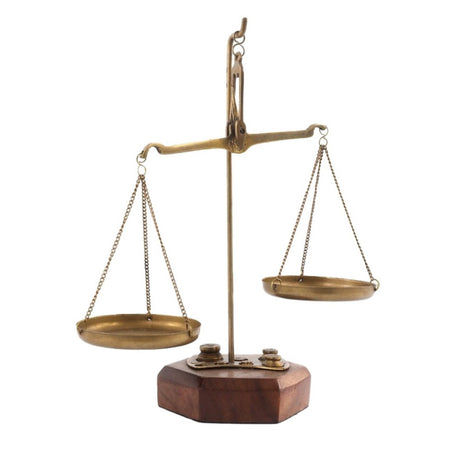 Elegant brass scales with wood accents, featuring an antique design, perfect for home decor or photography props.