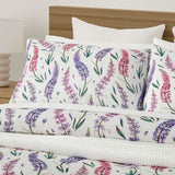 King duvet cover set featuring delicate pink and purple lupine flowers on white, made from 100% OEKO-TEX® cotton.