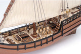 Detailed 1/65 scale model of La Niña Caravel, featuring laser-cut wood parts, brass fittings, and hand-sewn sails.