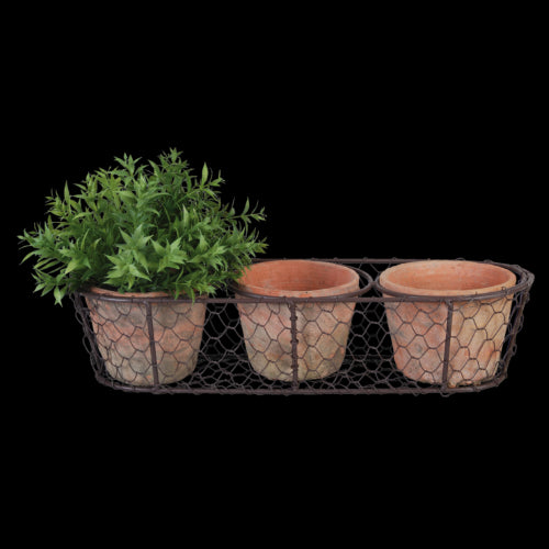 Rustic terracotta pots in a wire basket, perfect for indoor or outdoor plants, enhancing decor with Tuscan elegance.