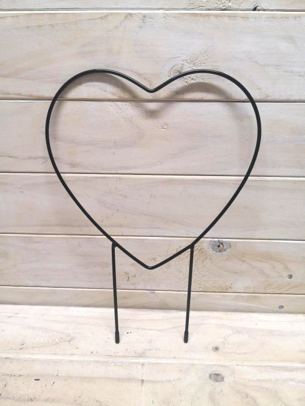 Heart-shaped metal garden stake providing support for plants while adding decorative charm to outdoor spaces.