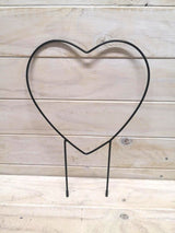 Heart-shaped metal garden stake providing support for plants while adding decorative charm to outdoor spaces.